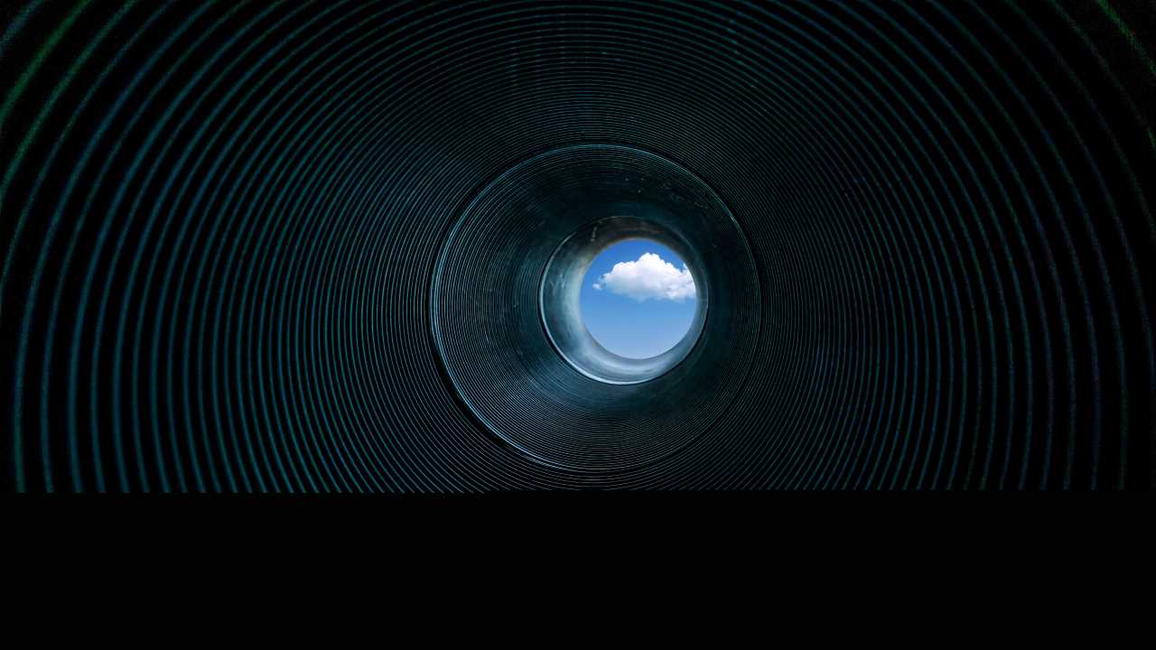 Looking at the sky with clouds through a pipe